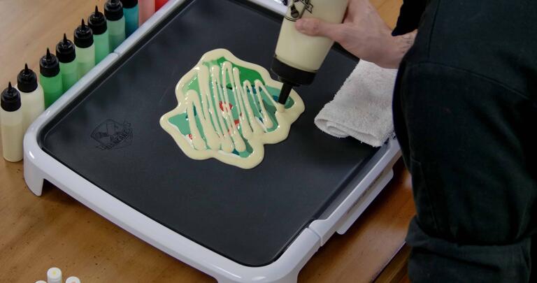 Bulbasaur pancake art step 7.3: We like to add a few zig-zags of extra batter to the back of your pancake art, to make sure no spots are missed and make the pancake a little thicker.