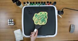 Bulbasaur pancake art step 9.1: Have confidence when you flip the pancake. Gently slide the spatula under the body of the pancake...