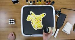 Pikachu Pancake Art step 7.3: Lastly, I like to zig-zag some plain batter across the back of my pancake designs. This adds a little bit more body to the pancake and, again, gives me more to eat!