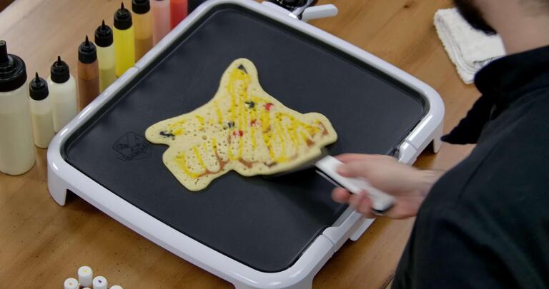 Pikachu Pancake Art step 9.1: When it's time to flip, the key is confidence! Be gentle and firm - align your spatula at the edge of your design, slide it under...