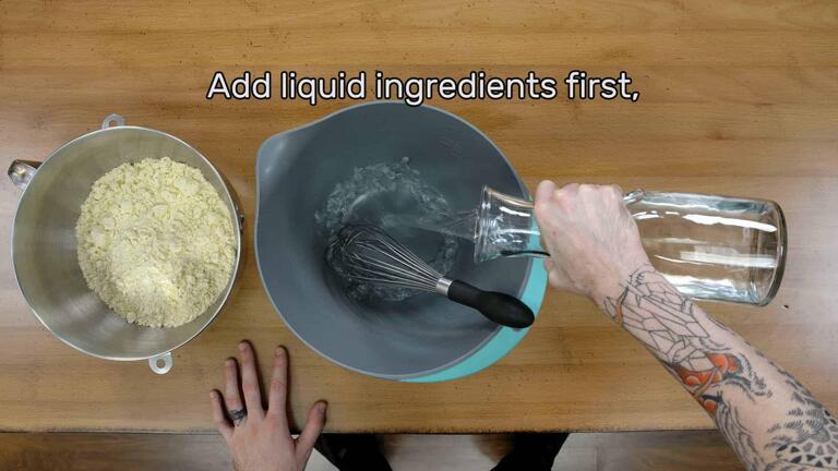 This image shows the water being added to a mixing bowl first, and says "Add liquid ingredients first."