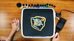 A photo of the pancake art design crafted in episode 3 of the joy of pancakes, showing a scene of planets with a space ship floating in space.